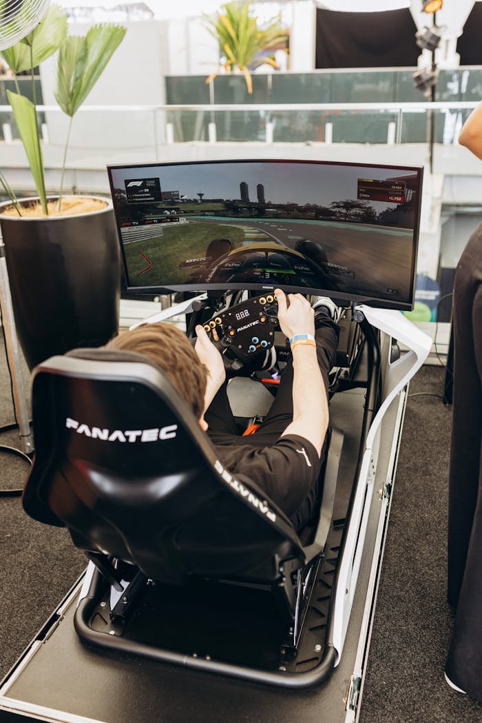 Adult using racing simulator indoors with a panoramic screen. Immersive experience.